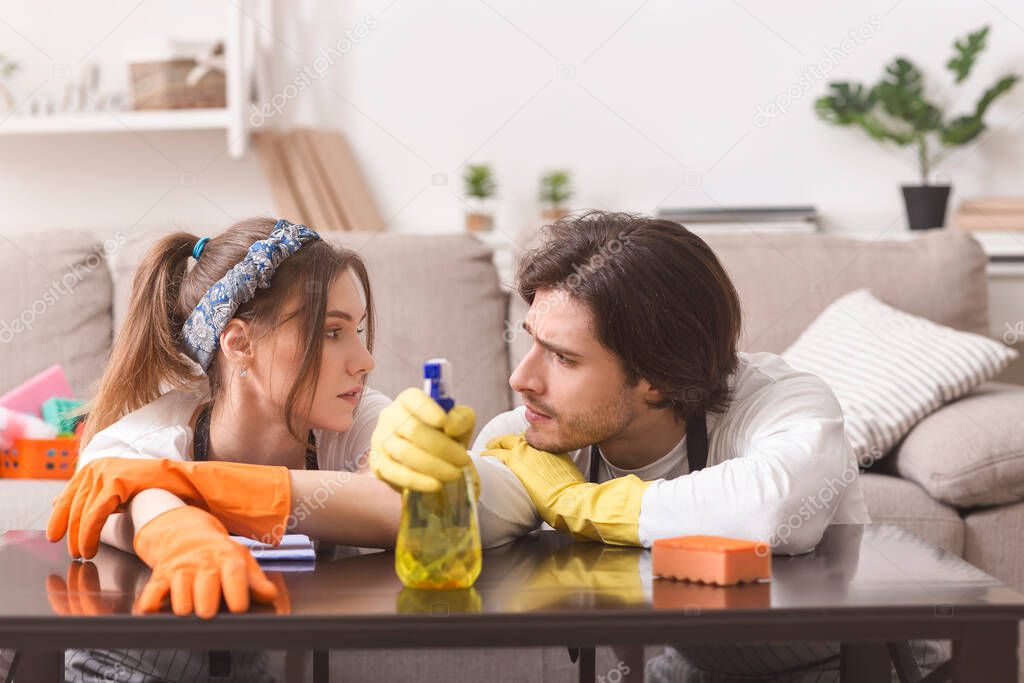 Tired Of Cleaning. Couple Leaning On Table Exhausted After Tidying Up Apartment