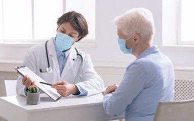 General practitioner showing analysis results to senior woman clipart