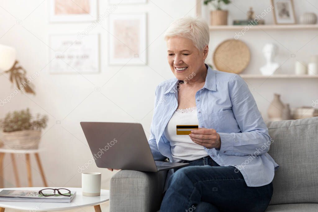 Online Payments. Senior Woman Using Laptop And Credit Card At Home