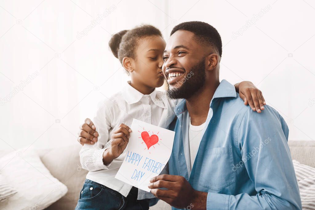 Happy Fathers Day. Cute Daughter Kissing Dad In Cheek