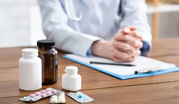 Prescription for pills to patient, jars of medicine on doctors table — Stock Photo, Image