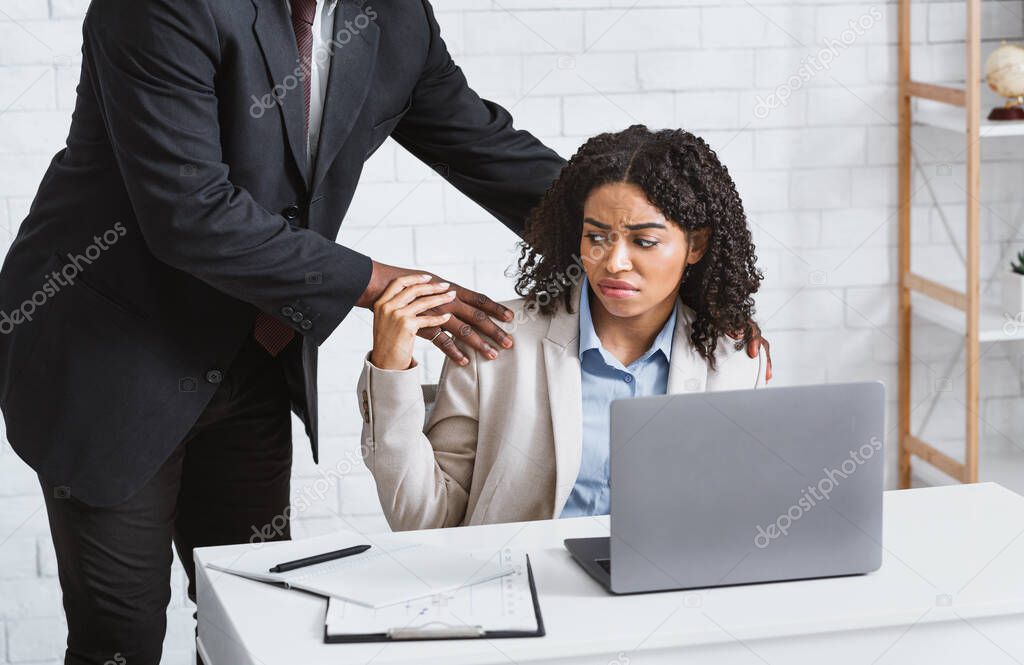 Workplace harassment. Disgusted female secretary stopping her boss from molesting her at company office