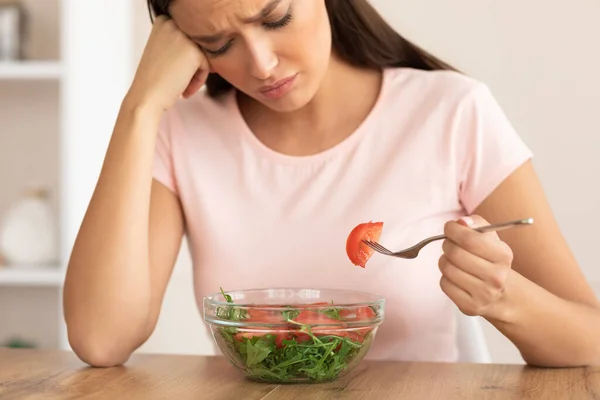 โศกเศร้าผู้หญิงกินสลัด Slimming นั่งที่โต๊ะที่บ้าน — ภาพถ่ายสต็อก