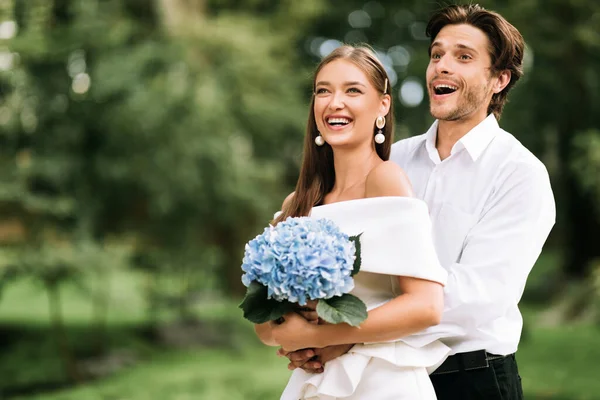 Happy Just-Married Couple Hugging Standing In Park Outside Celebrating Wedding — Stock Photo, Image