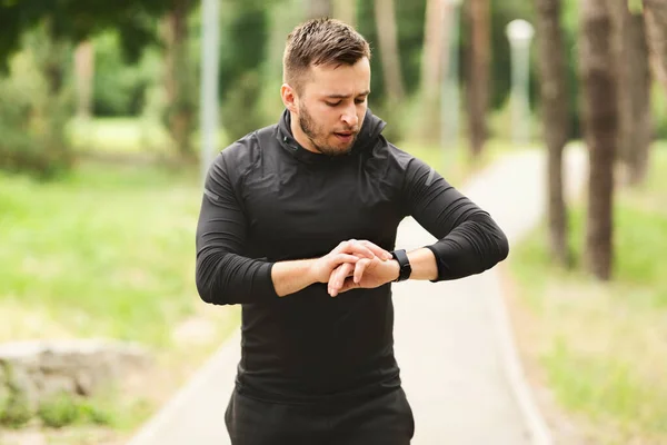 Man Running Checking Activity Tracker On Wrist Watch — Stock fotografie