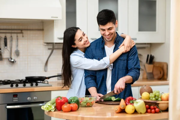 Giovane coppia preparare insalata insieme a casa — Foto Stock