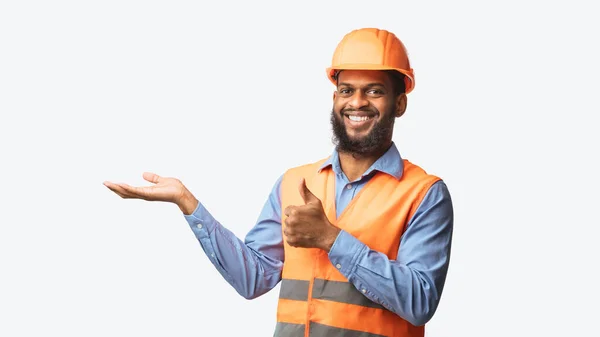 Construction Workman Holding Invisible Object Gesturing Thumbs-Up, Panorama, Studio Shot — Stock Photo, Image