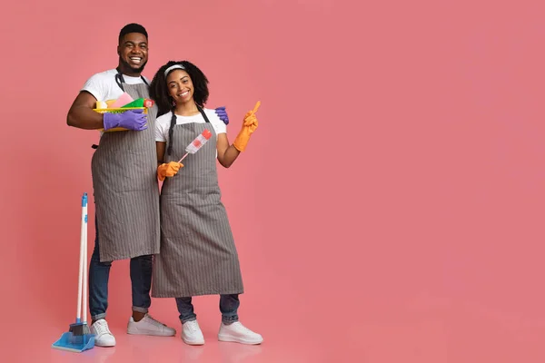 Cleaning Service Ad. Black Couple With Household Supplies Pointing At Copy Space — Stock Photo, Image