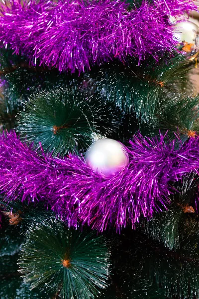 La guirnalda cuelga de un árbol de Navidad sintético —  Fotos de Stock