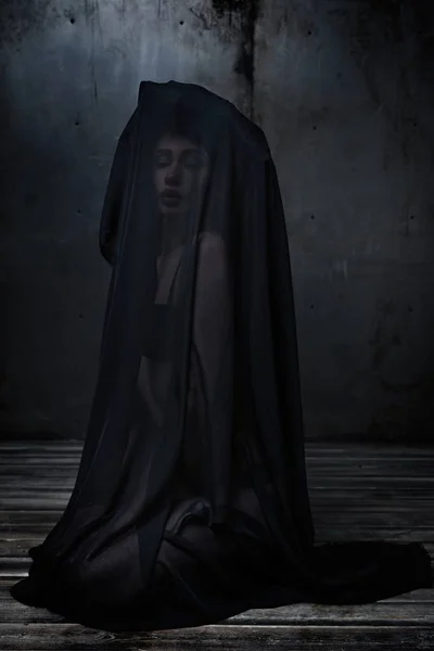 Woman veiled by sheer black fabric — Stock Photo, Image