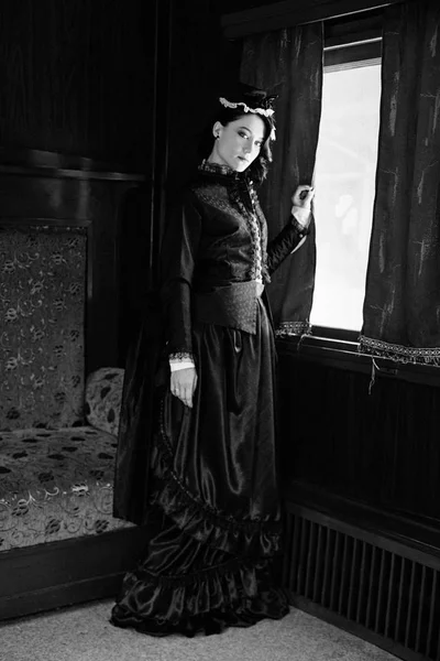 Woman in vintage dress in train — Stock Photo, Image