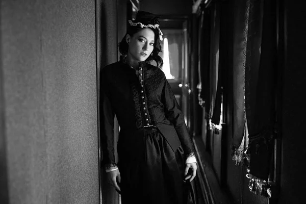 Woman in vintage dress in train — Stock Photo, Image