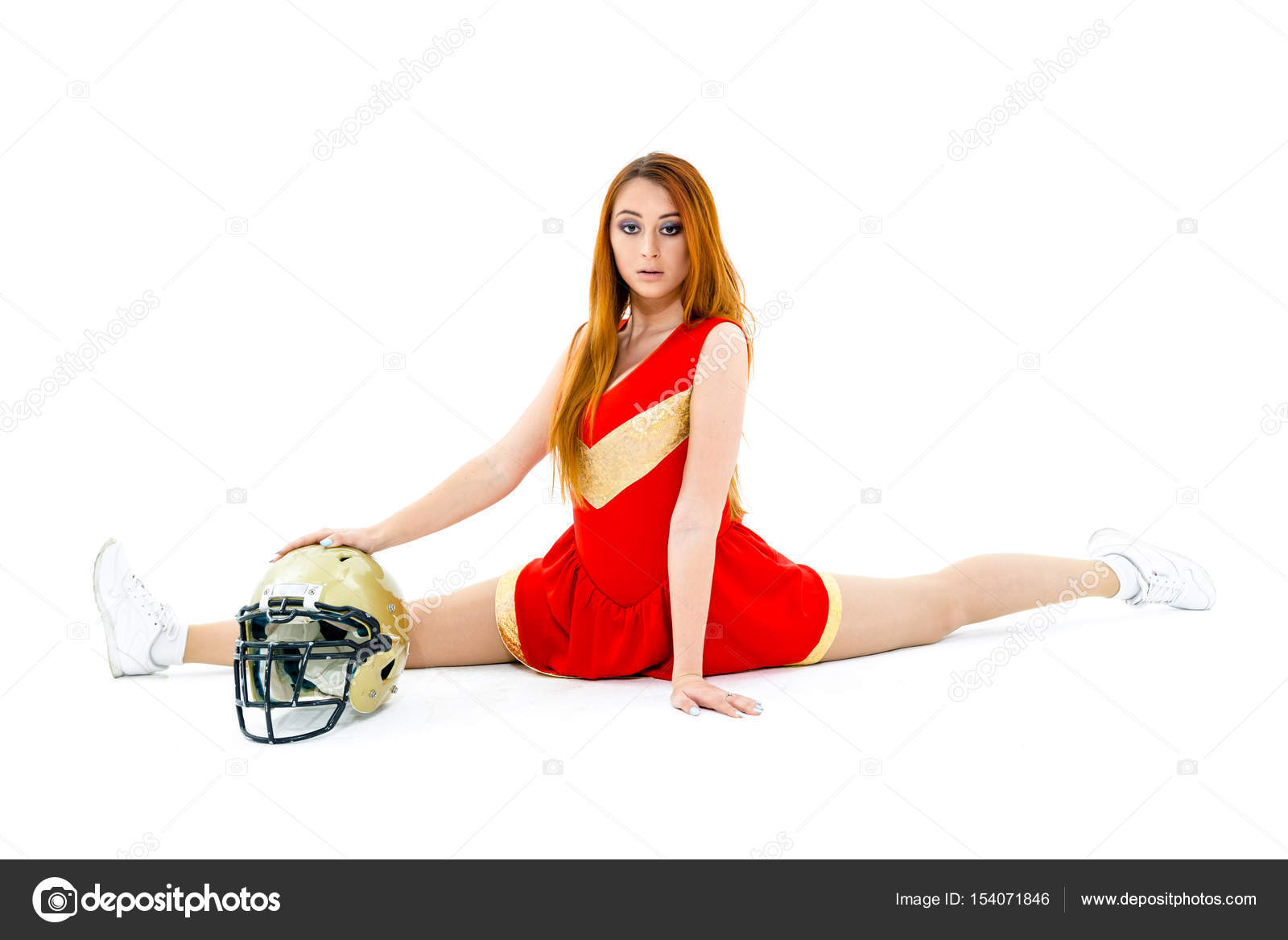 Cheerleader posing wih helmet Stock Photo by ©smmartynenko 154071846