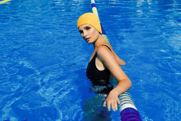 woman posing in swimming pool