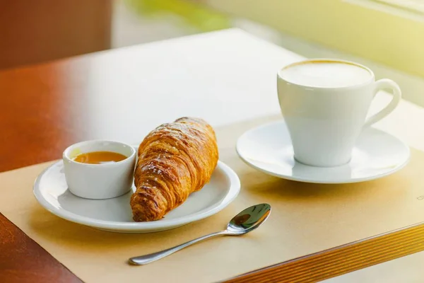 French croissant and honey — Stock Photo, Image