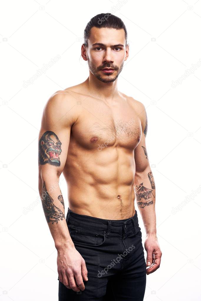 Handsome young shirtless tattooed man posing isolated on white background 