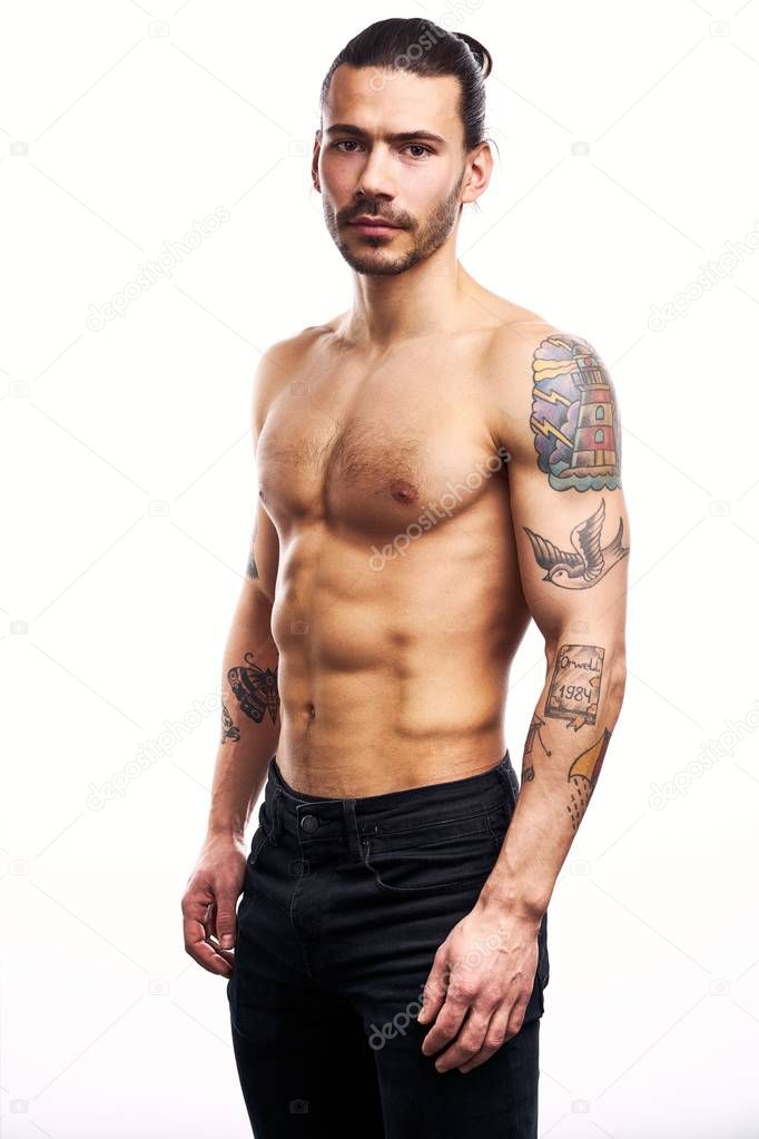 Handsome young shirtless tattooed man posing isolated on white background 