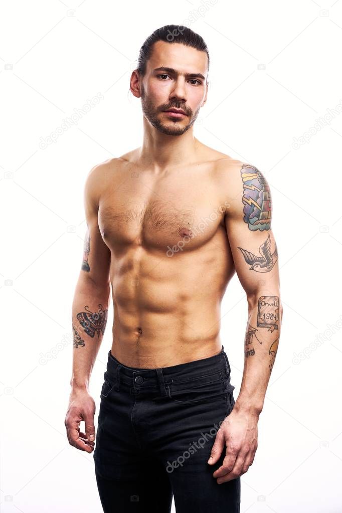 Handsome young shirtless tattooed man posing isolated on white background 