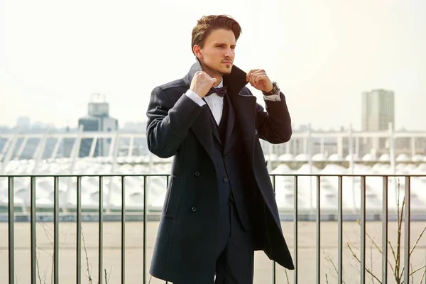 Stylish handsome young man posing on the street