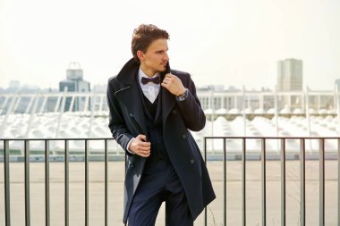 Şık yakışıklı genç adam sokakta poz