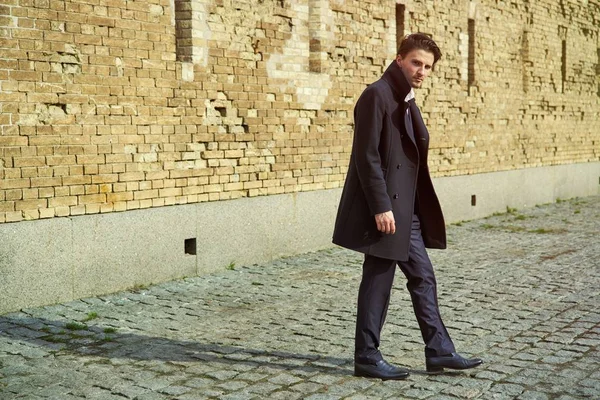 Stylish handsome young man posing on the street