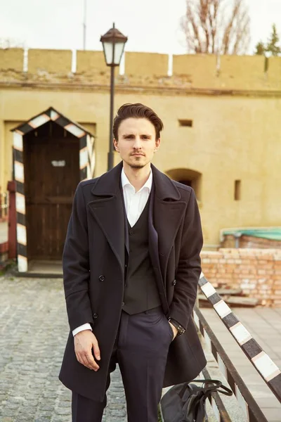 Stylish handsome young man posing on the street