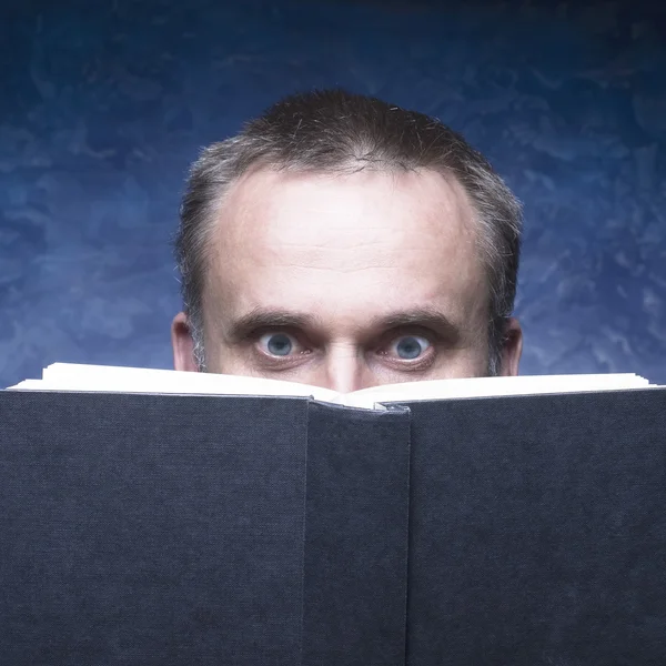 Mature man being focused and hooked by book. — Stock Photo, Image