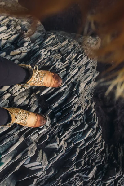 Legs in boots standing on stones — Stock Photo, Image