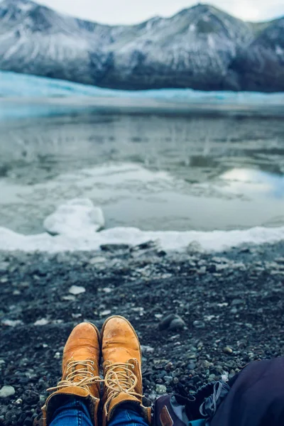 Legs in boots over ice — Stock Photo, Image