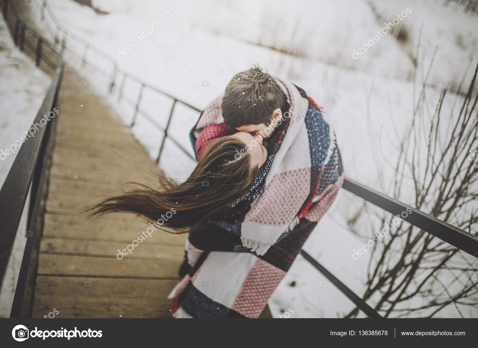 Kissing lovers wrapped in blanket — Stock Photo © KristinaPonomareva
