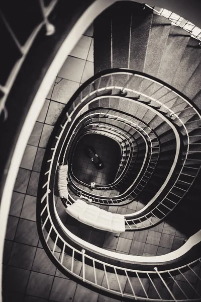 spiral stairs and hugging couple