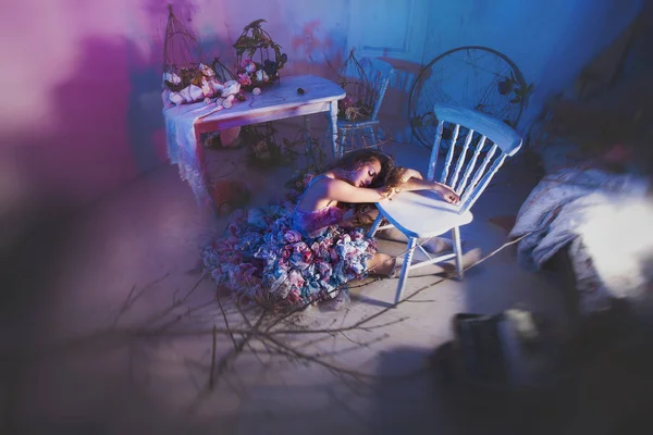 woman laying on floor near armchair