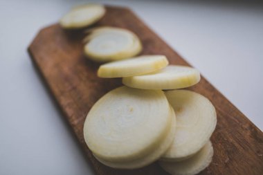 Kesme tahtasında dilimlenmiş soğan