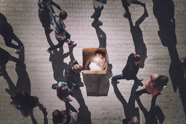 woman sitting inside of cardboard box