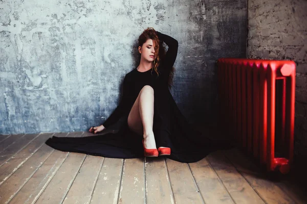 Frau in Kleid und roten Schuhen auf dem Boden — Stockfoto