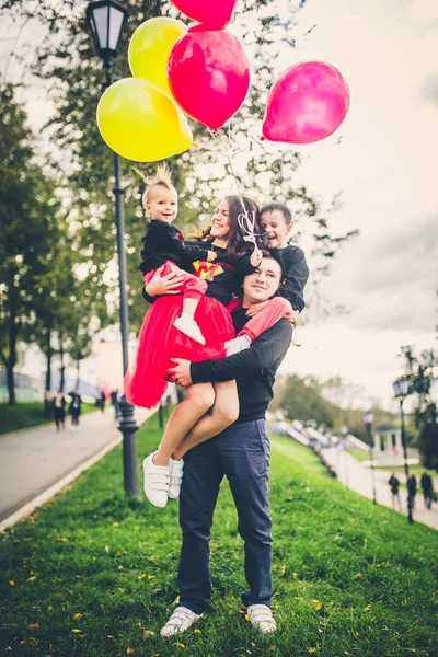 family in park with balloons