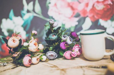 güzel renkli çiçekler yakın beyaz fincan kahve ahşap arka plan üzerinde ile çekim