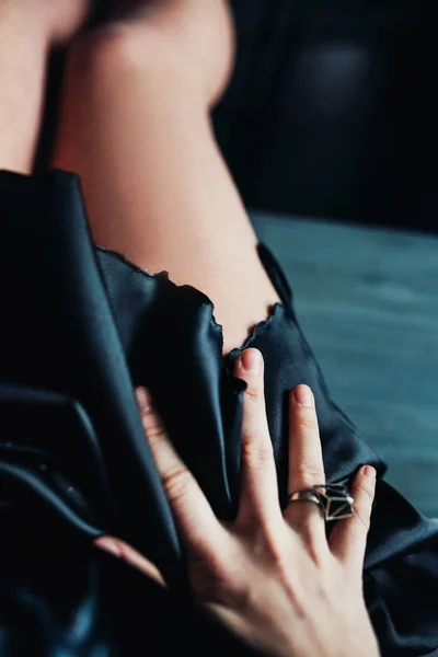 Close Woman Hand Fashion Ring Legs Black Satin Dress Blurred — Stock Photo, Image