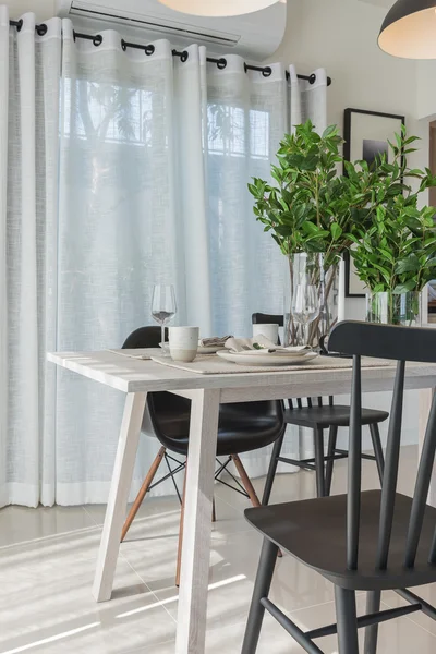 Modern dinning room with black modern chair and vase of plant — Stock Photo, Image