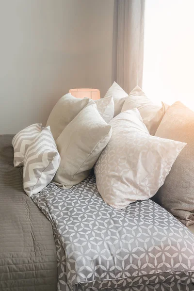 Set of pillows on bed in cozy bedroom — Stock Photo, Image