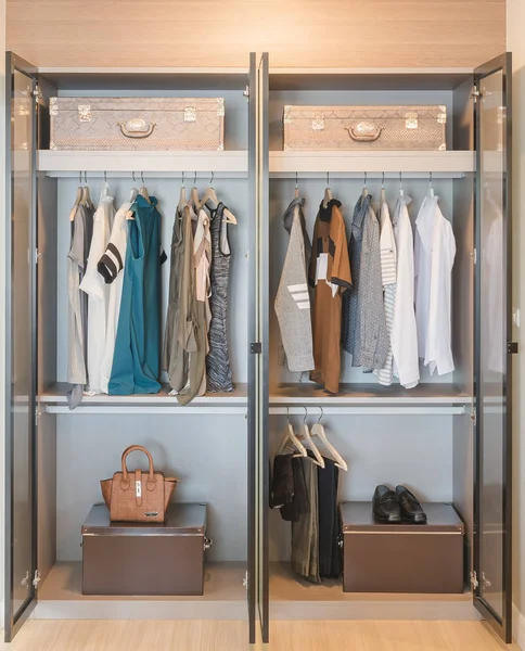 Kleren opknoping op spoor in moderne garderobe — Stockfoto