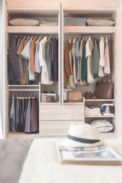 Colorful clothes hanging on rail — Stock Photo, Image