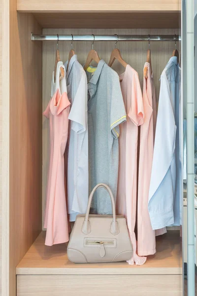 Set of clothes hanging on rail — Stock Photo, Image