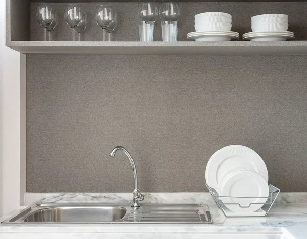 modern kitchen room with sink on granite counter top