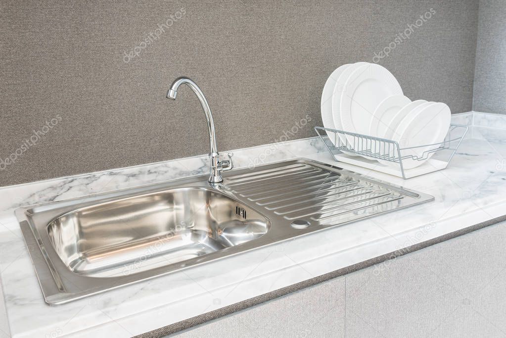 modern kitchen room with sink on granite counter top