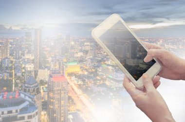 Yazarken akıllı telefon elinde tutan genç kadın