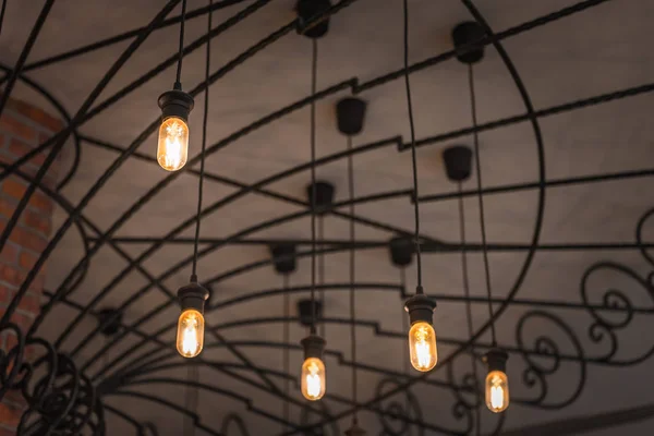 group of hanging lights in coffee shop with shallow depth of fie