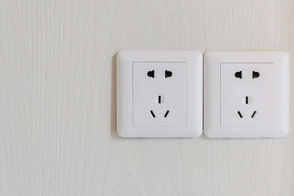 White electric plugs or outlet on wall — Stock Photo, Image