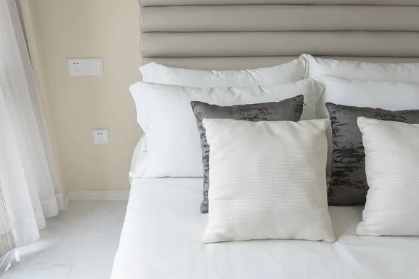 Quarto moderno com conjunto de travesseiros na cama branca — Fotografia de Stock