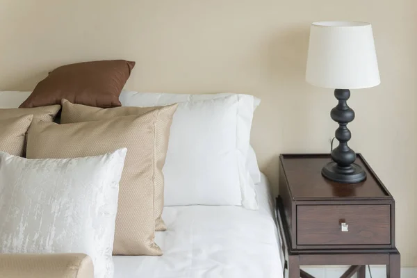 Set of brown pillows on bed in classic bedroom Royalty Free Stock Photos